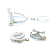 Puccissime Swan white luxury vegan leather dog accessories matching set. Norwegian one click no pull no choke no mat easy wear dog harness, dog collar bow tie and leash and dog poop bag. MADE IN CANADA.